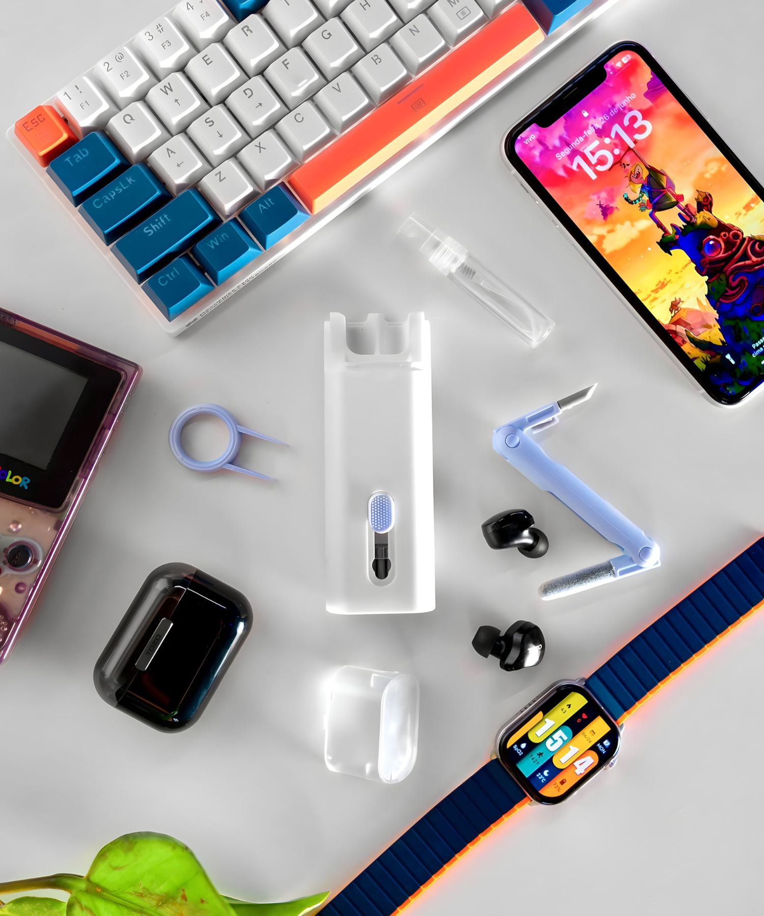 asthetic picture containing mechanical keyboard, airpods, iphone gadget cleaner and nintendo gameboy