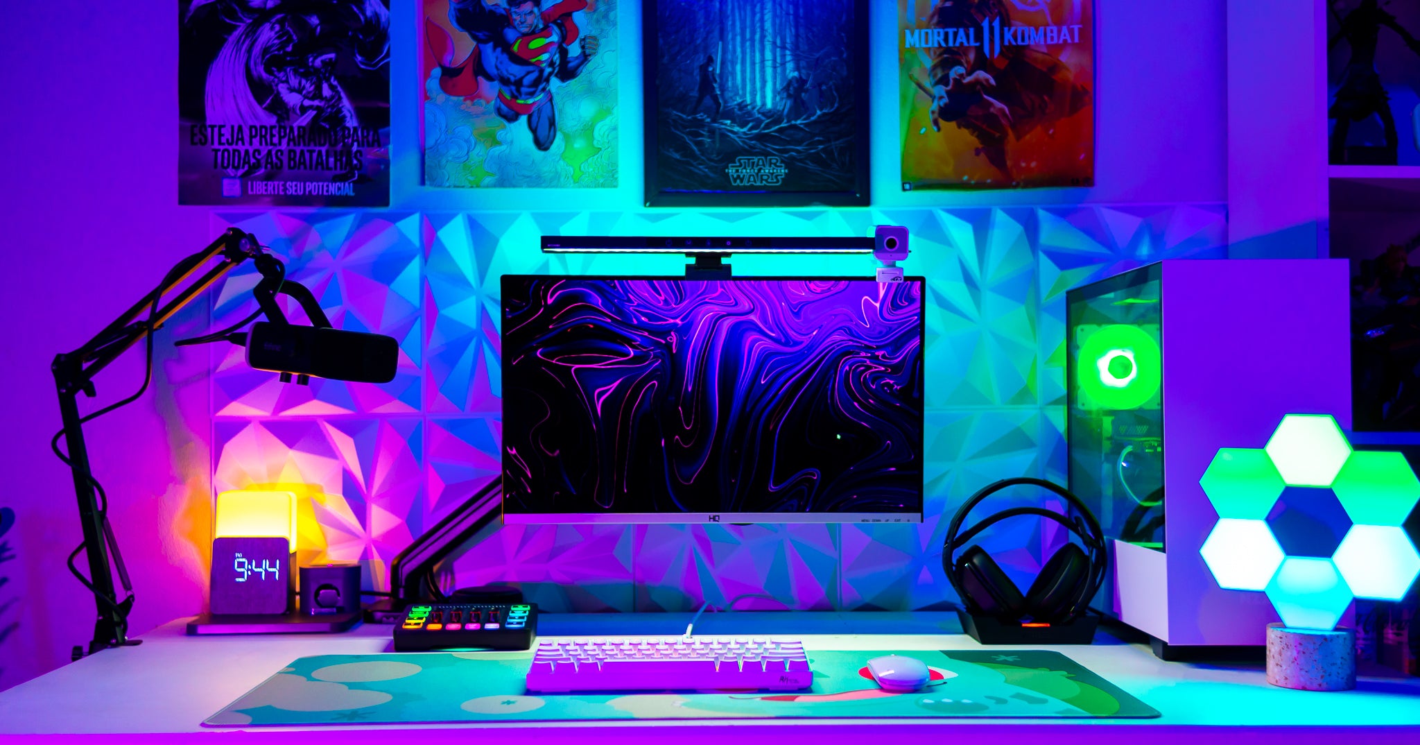 purple and green rgb lit gaming setup with wall art