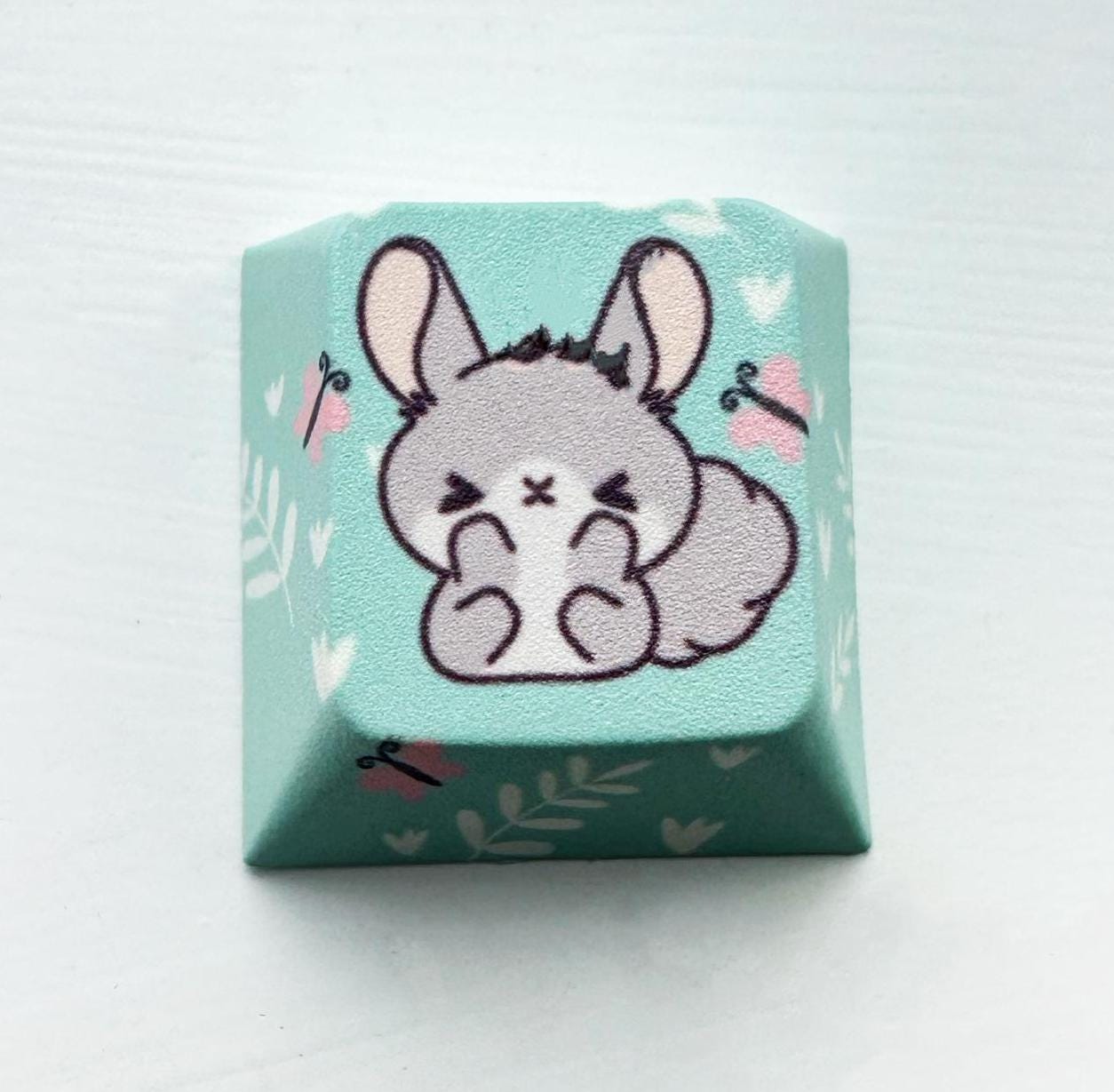 Grey bunny keycap blue background pink butterfly