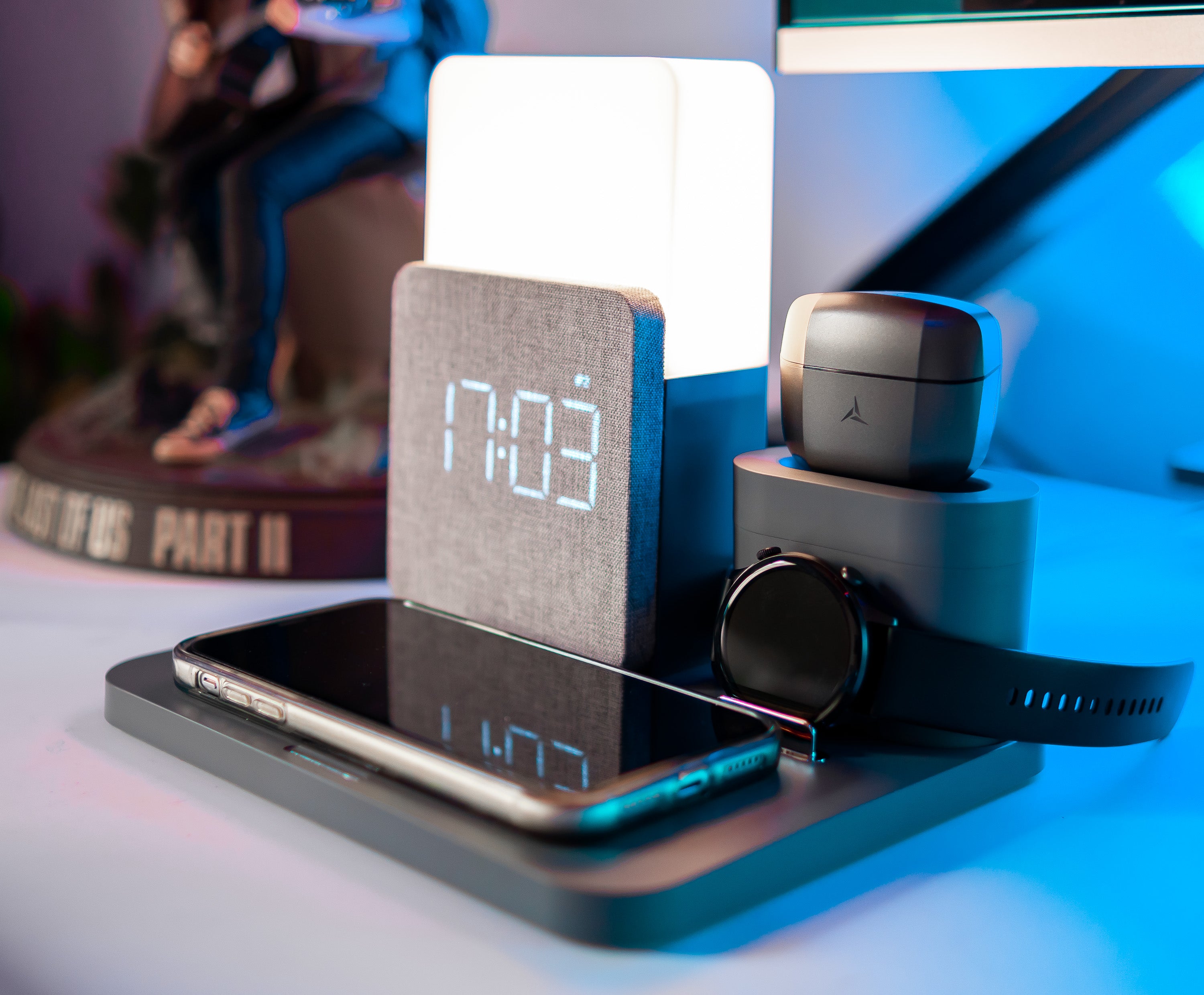 dark grey alarm clock with wireless charging iphone, airpods and apple watch in gaming room