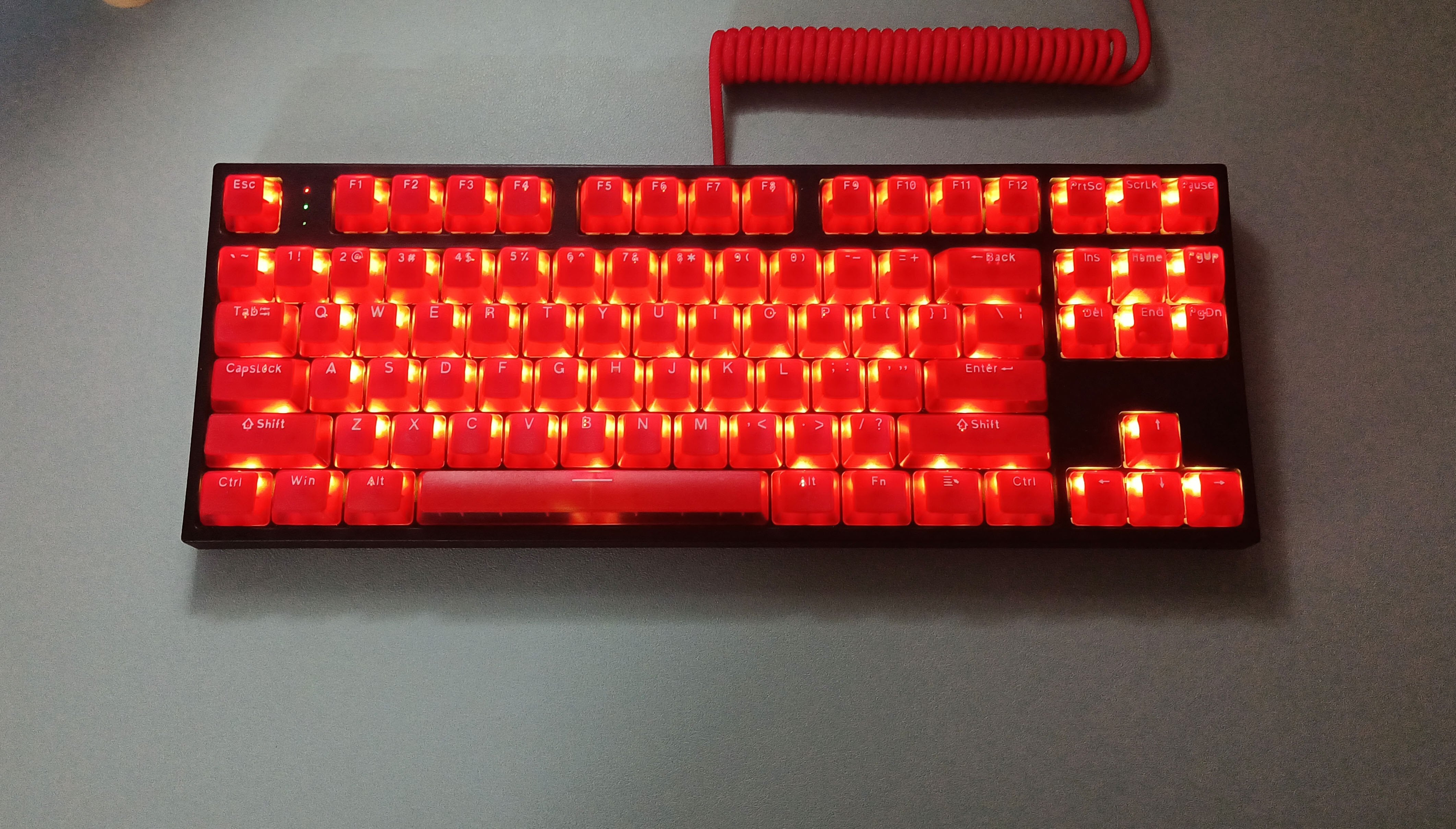 red transparent keycap set on a rgb lit black mechanical keyboard