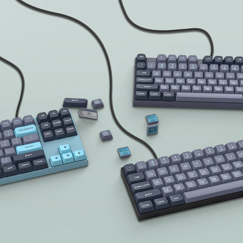 3 gaming mechanical keybaords showcasing grey and dark blue keycaps