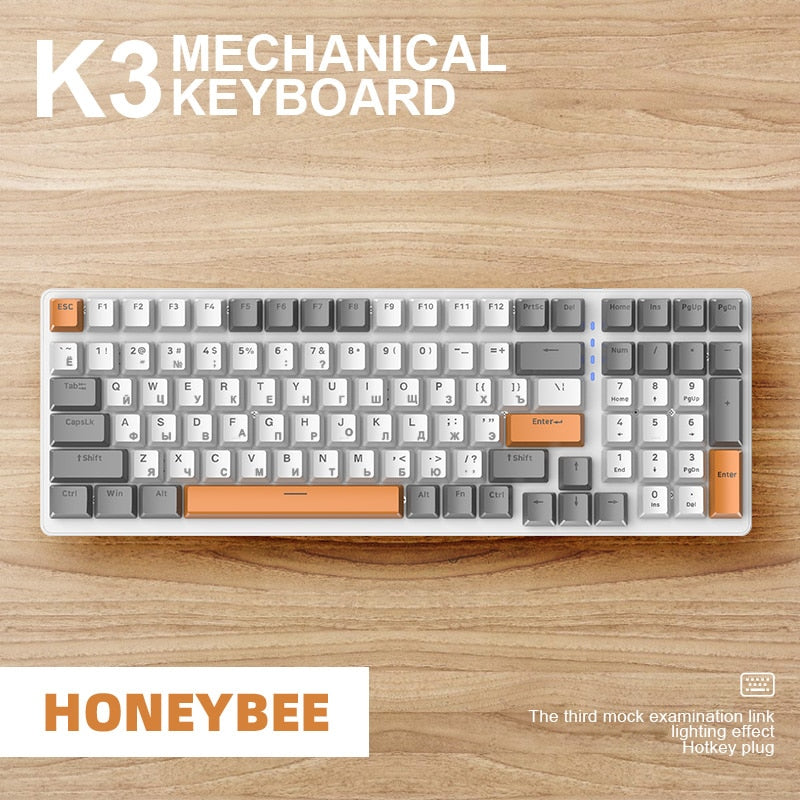 white, grey and orange mechanical keyboard on wood background
