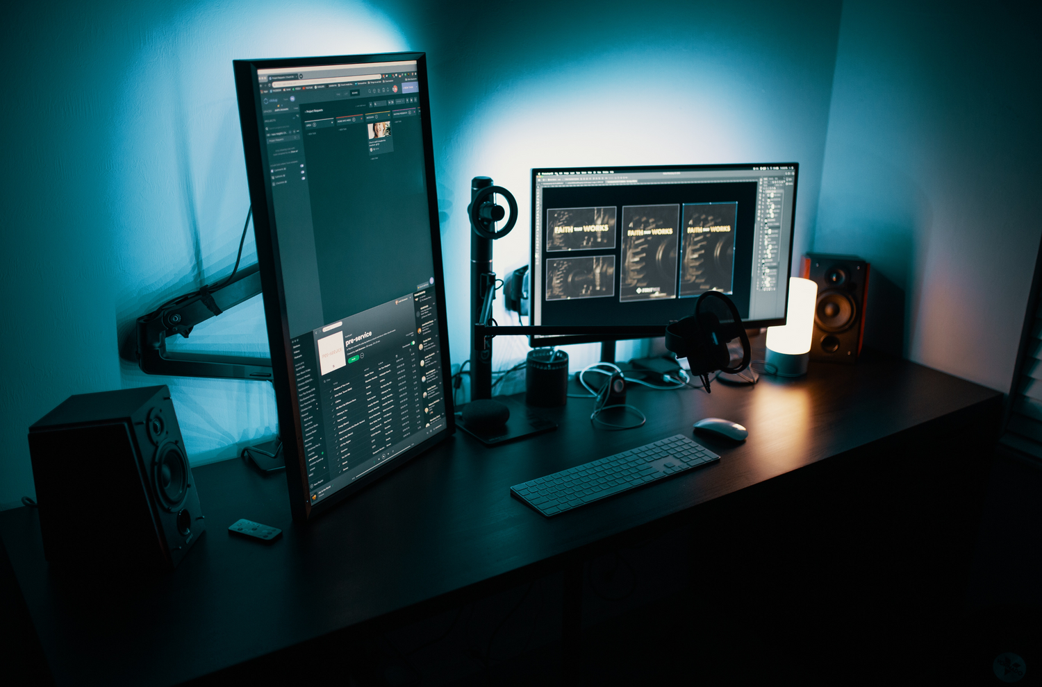 A dual monitor gaming setup, featuring two side-by-side displays on a desk, with a keyboard, mouse, and gaming headset, all illuminated by ambient RGB lighting.