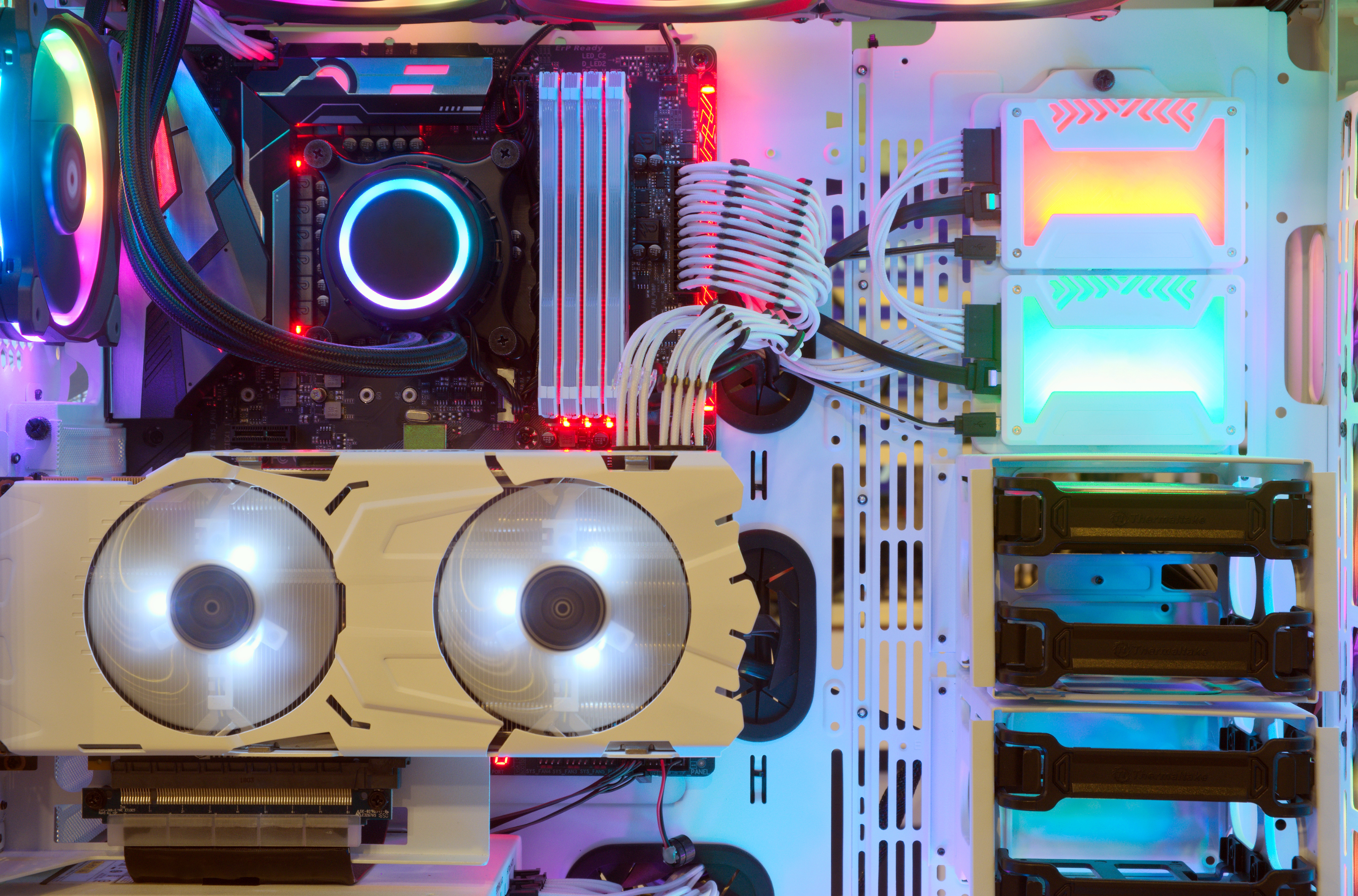 An image of a sleek white PC with a transparent side panel, revealing a matching white GPU, creating a clean and unified aesthetic for the computer's interior components.