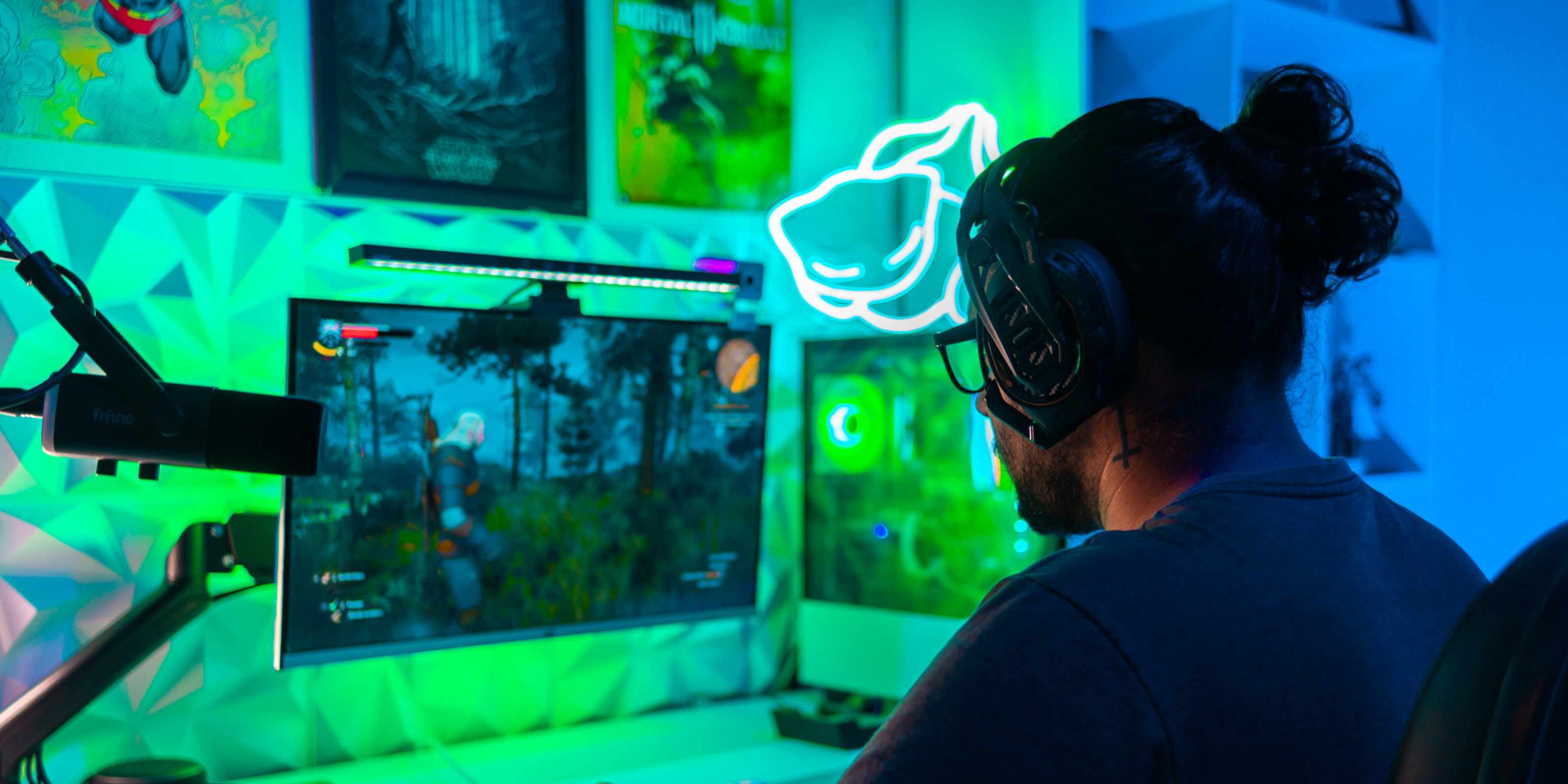 gamer playing the witcher 3 with green gaming setup
